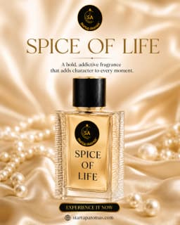 A premium bottle of Spice of Life luxury perfume by Startup Aromas, filled with clear golden juice and resting elegantly on draped, shimmering champagne silk fabric. The bottle is framed by strands of classic white pearls and scattered loose pearls under 